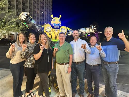 Academy ISD Board of Trustees taking a photo with Bumblebee!